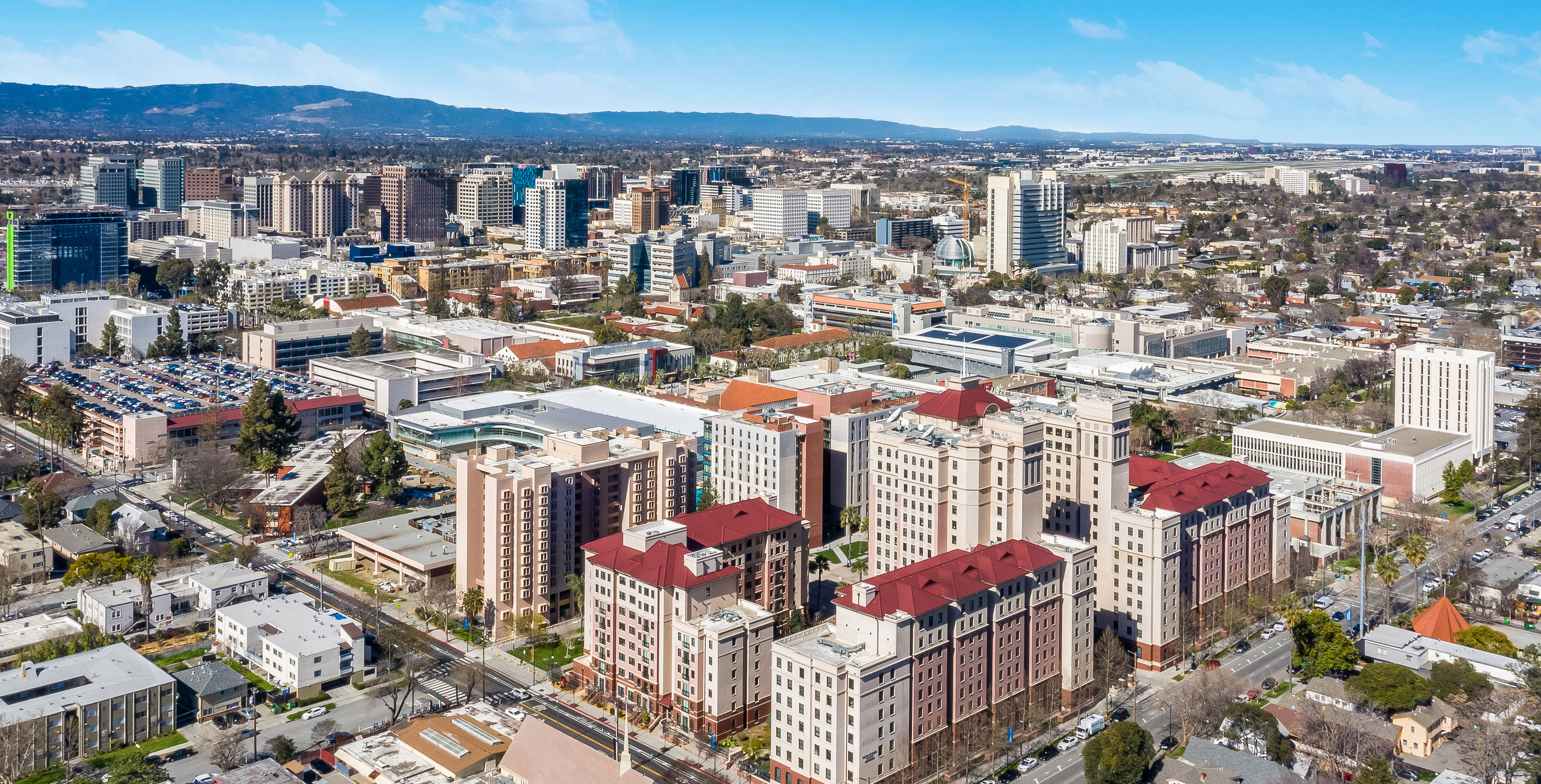 Arial shot of the SJSU Campus from above the Campus Village, looking outwards to downtown San Jose. 