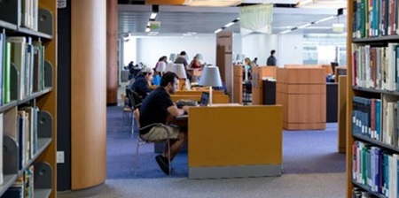 Students studying at desks in a library 