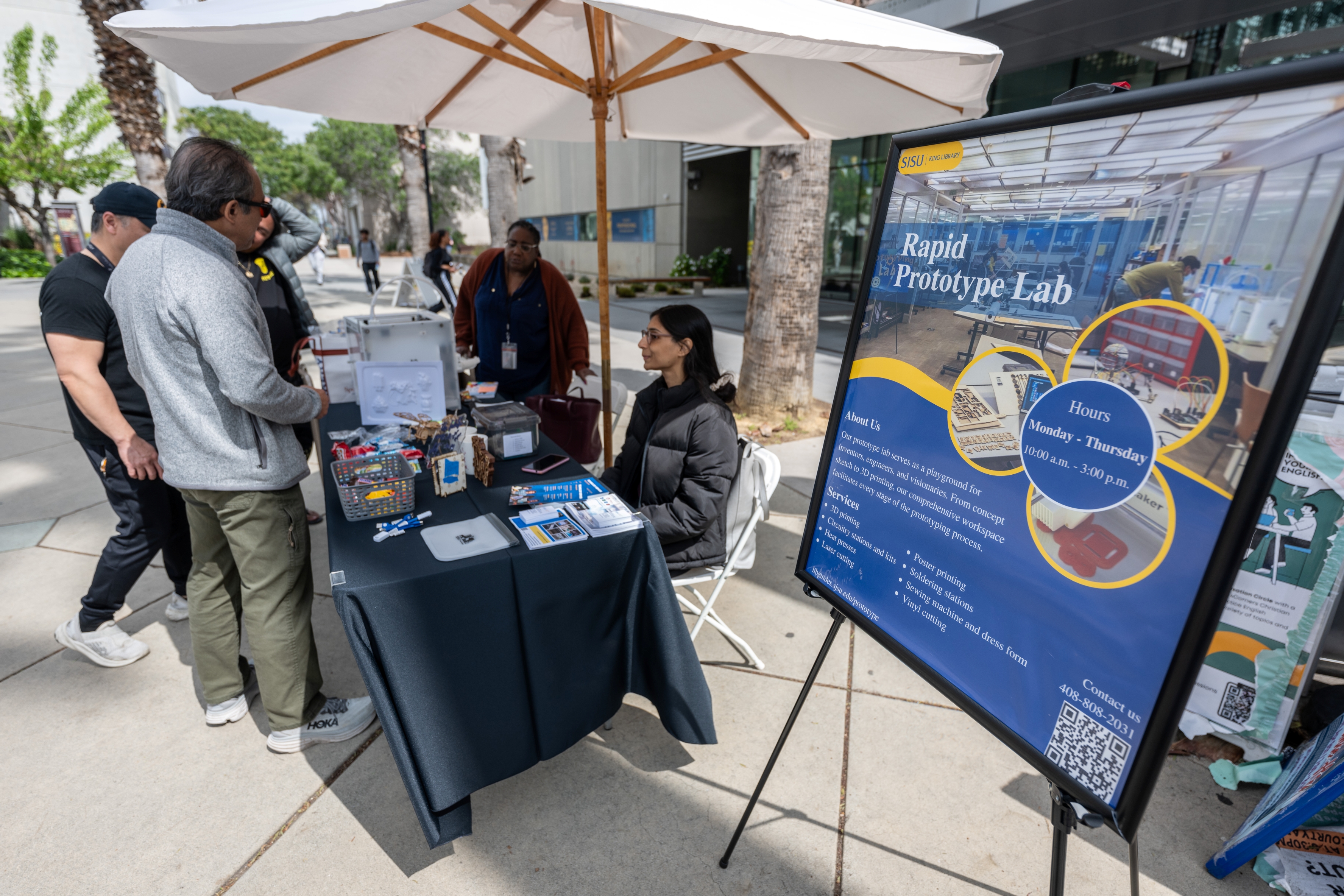 Spectators looking at a display by the MLK Library Prototyping Lab