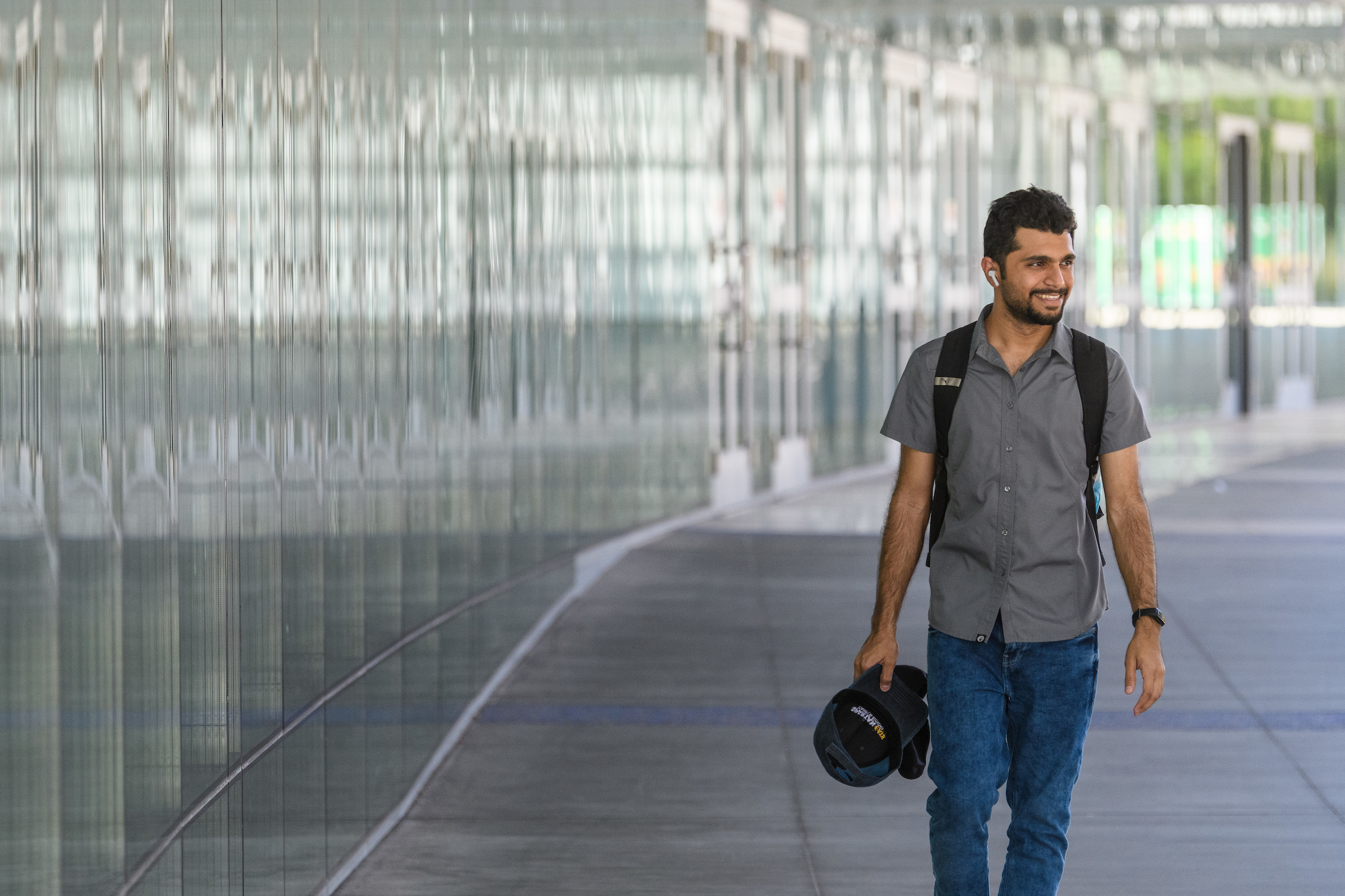 SJSU student walking towards camera and smiling