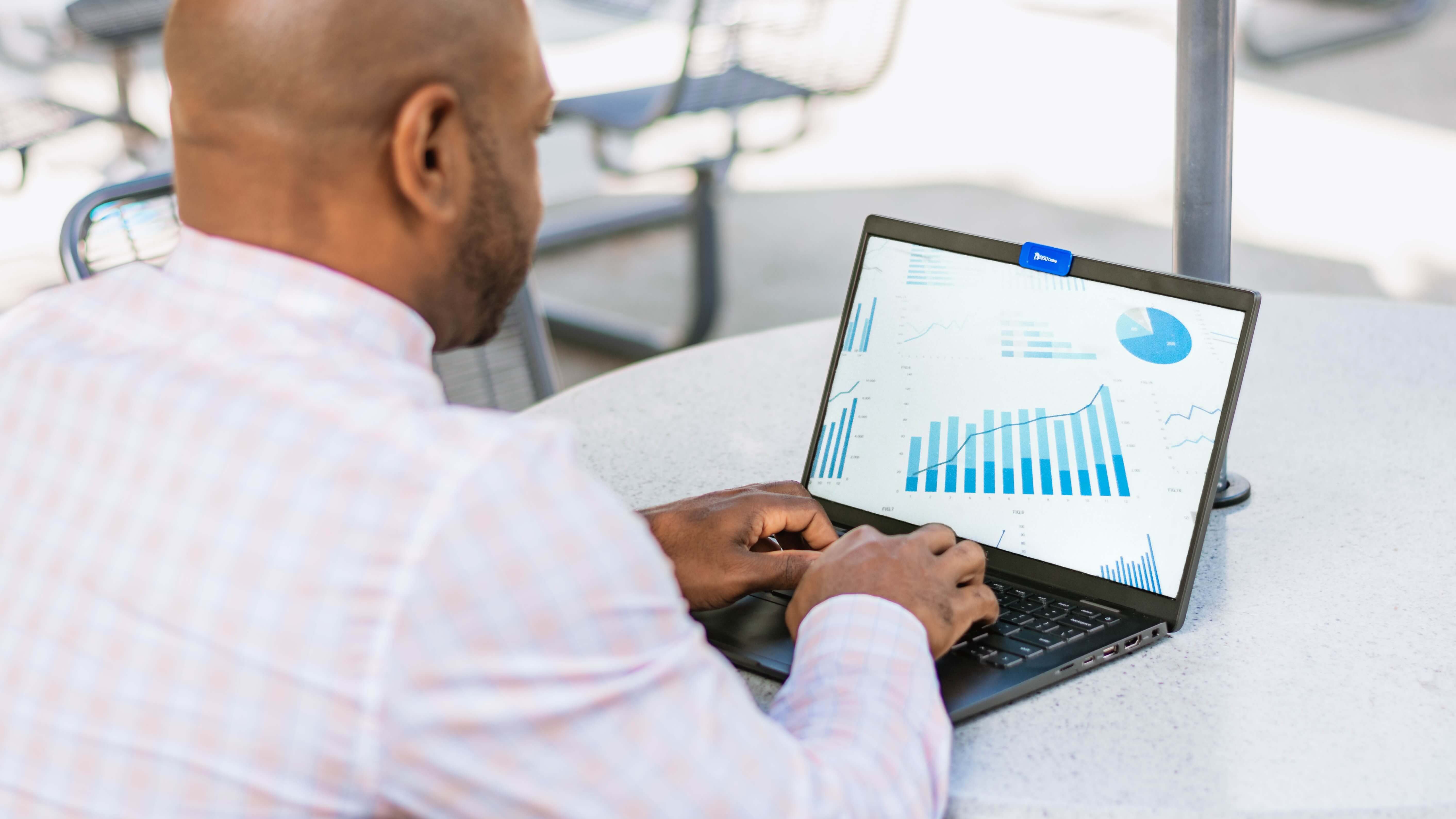 Man on laptop looking at graphs